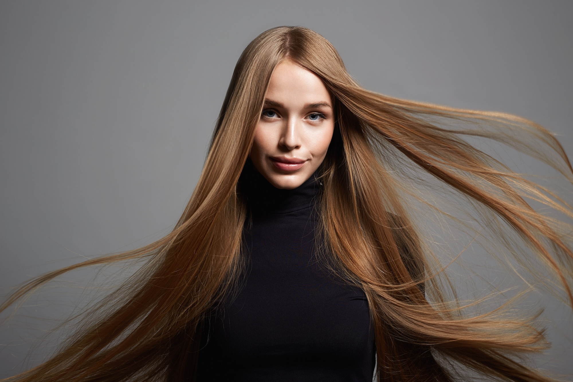 beautiful blond young happy woman. beauty portrait of pretty smiling girl with Healthy flying Hair